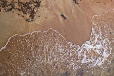 Sandy beach and waves. View from above. Stock Photos