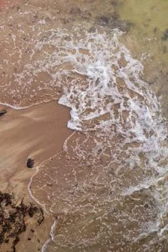 Sandy beach and waves. View from above. Stock Photos