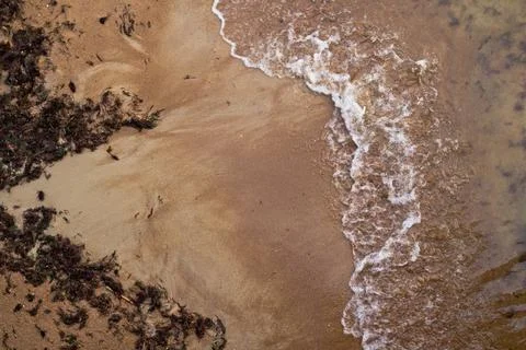 Sandy beach and waves. View from above. Stock Photos