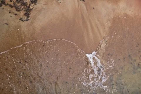 Sandy beach and waves. View from above. Stock Photos