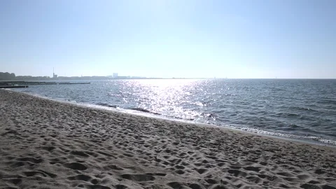 Sandy beach on the baltic coast. Blue sky, sunshine, sparkling sea water. Stock Footage 155093874