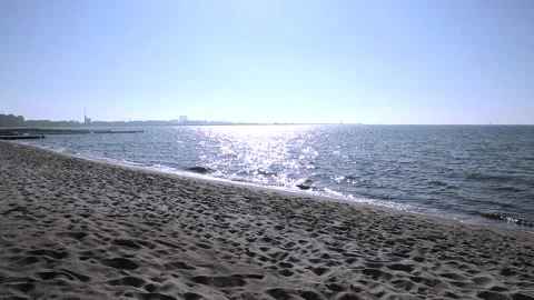 Sandy beach on the baltic sea. Blue sky, sunshine, sparkling sea water. Stock Footage 155094099