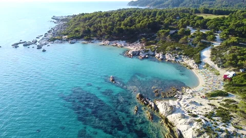 Sandy beach with beach bar and rocks on the coast and exotic sea. Aerial view Stock-Footage 136003178