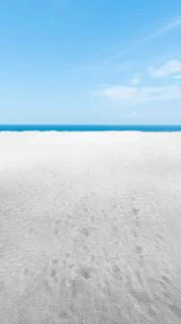 Sandy beach with the blue ocean Stock Photos