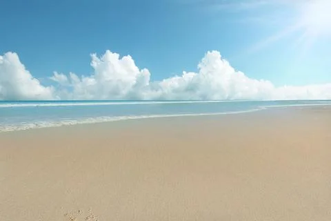 Sandy beach with the blue ocean Stock Photos