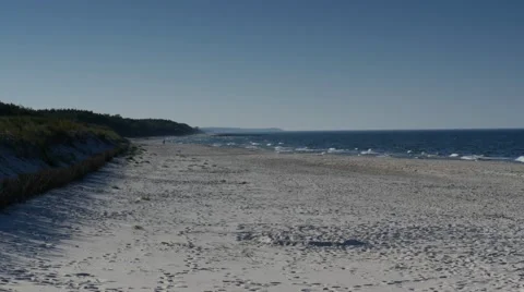 Sandy beach, blue sky, sand, sea water, waves on Baltic sea. (Ultra HD, UHD, 4K) Stock Footage 42810545