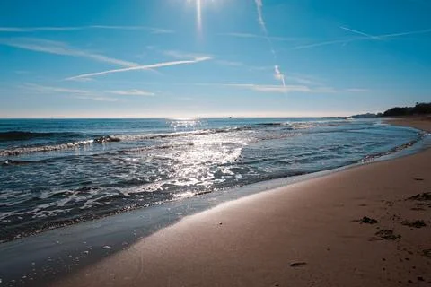 Sandy beach of the Bolearic sea with beautiful waves against the background o Stock Photos