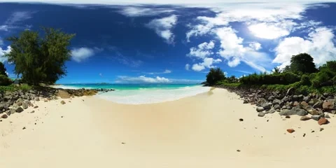 A sandy beach bordered by rocks and clear waters. Praslin, Seychelles. Stock Footage 301161320