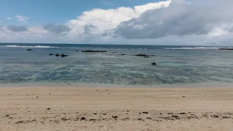 Sandy beach with clear water and scattered rock formation. Siargao, Philippines. Stock Footage 323484087