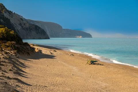Sandy beach with cliffs and calm turquoise sea Photos