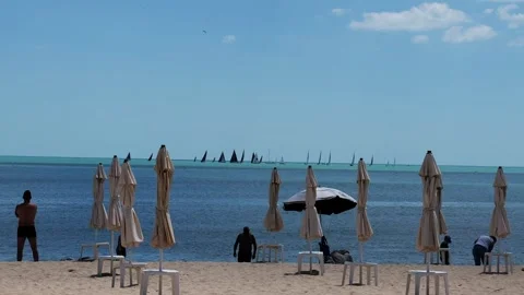 Sandy beach with closed umbrellas and chairs Stock Footage 335637985