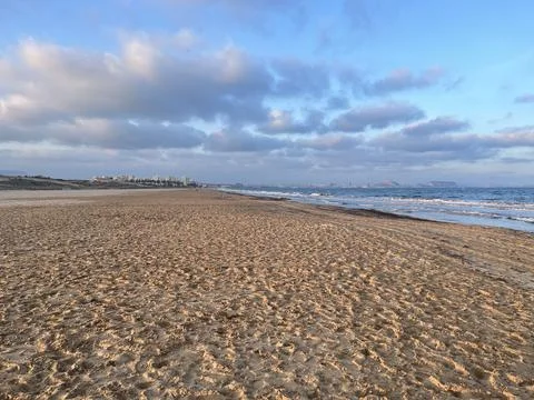 Sandy beach with clouds and sun Stock-Fotos