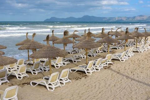 Sandy beach on a cloudy day in Can Picafort, tourist resort in northern Mallorca Stock Photos