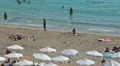 Sandy beach of Coral Bay resort with people and parasols on sand, Cyprus HD Footage
