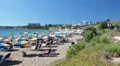 Sandy beach in Coral Bay with sunbathing people, Peyia, Paphos, Cyprus HD Footage