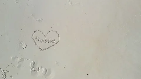 Sandy beach with drawn heart shape Stock Footage 132555118