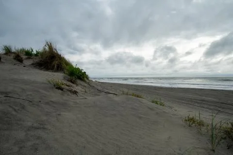 A Sandy Beach Dune With a Dramatic Stormy Sky Over It Stock Photos