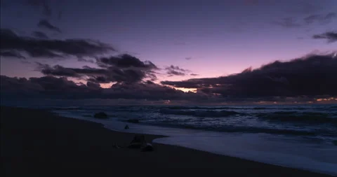 Sandy beach at dusk in winter, time lapse with vivid purple gradient sky Stock Footage 145943048