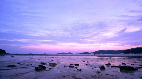 Sandy beach at ebb time with sea waves reflecting sunset light. Yachts in the Video stock 66879903