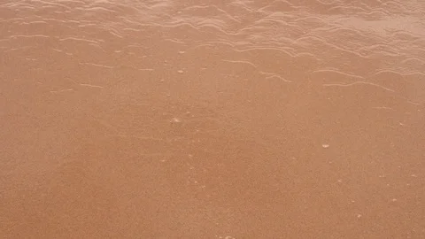 Sandy beach with fine waves that have white foam crests 스톡 동영상 94675575