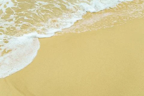 Sandy beach with foamy waves Stock Photos