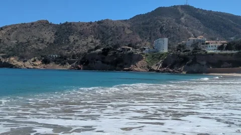 Sandy beach with frothy waves at ALtea Spain Stock Footage 306242251