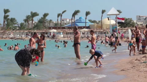 Sandy beach full of people is on the Red Sea coastline, Hurghada, Egypt Stock Footage 57364446
