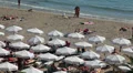 Sandy beach full of people sunbathing, playing and swimming on Coral Bay, Cyprus HD Footage