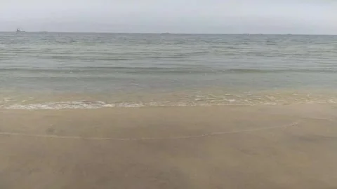 Sandy Beach with Gentle Ocean Waves Horizon 1080p Stock Footage 335957494