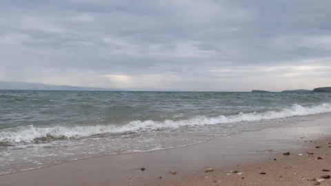 Sandy beach in inclement weather. Waves of the sea surf on a cloudy day Video stock 197283161