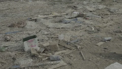 A sandy beach littered with garbage and plastic waste Stock Footage 243033185