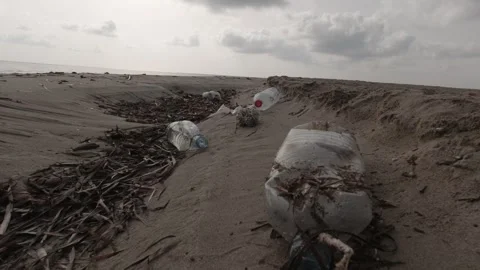 A sandy beach littered with garbage and plastic waste Stock-Footage 243038319