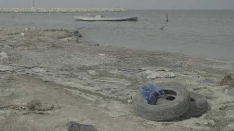A sandy beach littered with garbage and plastic waste Stock Footage 244406889
