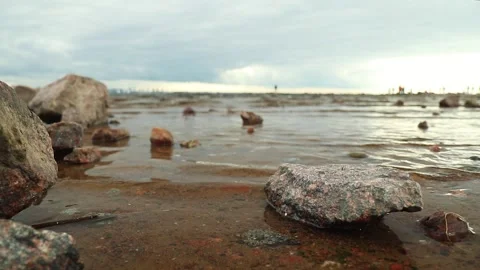 Sandy beach with many rocks and sea waves on the coast 動画素材 142375595