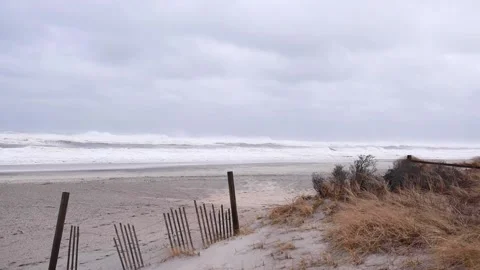 A sandy beach next to a fence Stock Footage 155593550