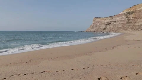 A sandy beach next to the ocean Video stock 156017261