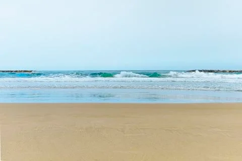 A sandy beach next to the ocean Stock Photos
