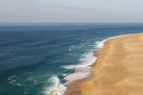 Sandy beach of the ocean, side view. Stock Photos