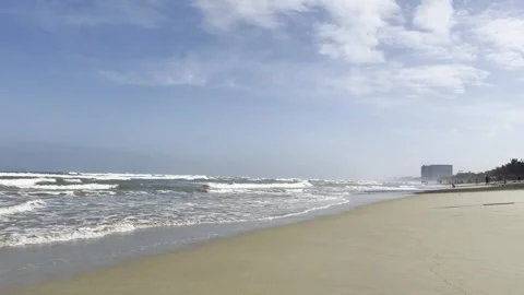 Sandy beach with ocean waves and palm trees in Da Nang, Vietnam Video stock 323928106