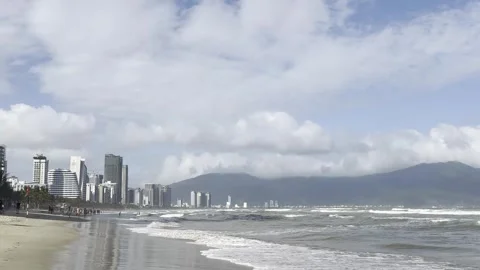 Sandy beach with ocean waves and palm trees in Da Nang, Vietnam Video stock 323928314