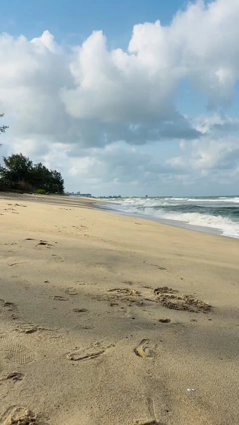 Sandy beach with ocean waves and cloudy sky in Kuala Terengganu Stock Footage 328132427