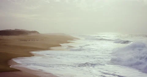 Sandy beach with ocean waves splashing and breaking in slow motion, Nazare Stock Footage 156284641