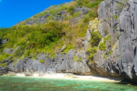 Sandy Beach with Palm Shadows, Huge Rocks, El Nido, Palawan, Philippines Stock Photos