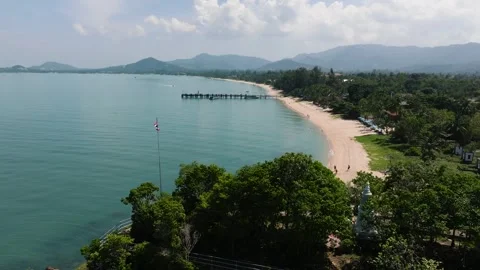 Sandy beach with pier and distant hills. Ko Samui, Thailand. Stock Footage 307253676