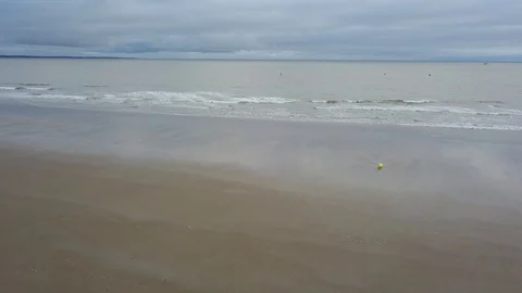 Sandy beach resort on a cloudy day. Aerial drone shot. Stock Footage 128378744