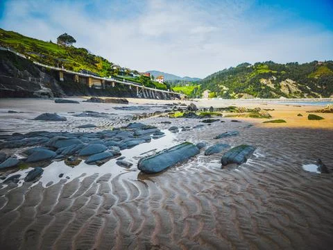 Sandy beach with rock formations and tidal pools in Deba, Basque Country, Spain Foto stock