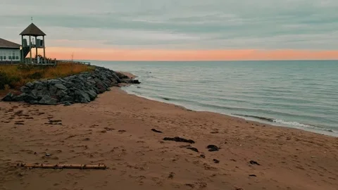 Sandy Beach With Rock Line And Gentle Waves Rolling Up On Shore Stock-Footage 255322035