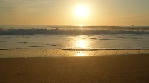 Sandy beach with rolling waves during sunset in summer. Stock Footage 304101702