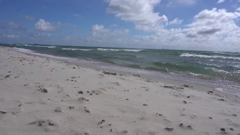 Sandy Beach with Rough Waves and Town of Skagen on Horizon, North Denmark Stock Footage 336013366