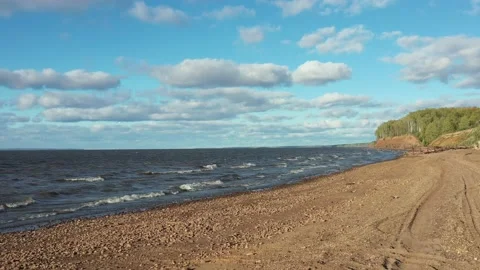 Sandy beach by the sea in strong wind and waves Stock Footage 166742626